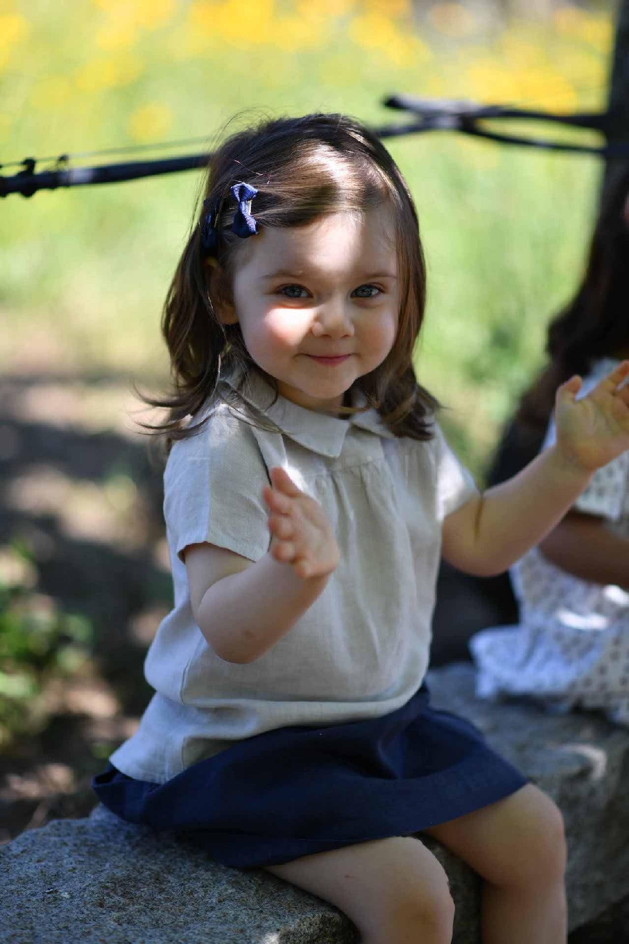 A stylish cream casual shirt made of 100% linen, featuring short sleeves, a round collar, and a snaps closure on the back.