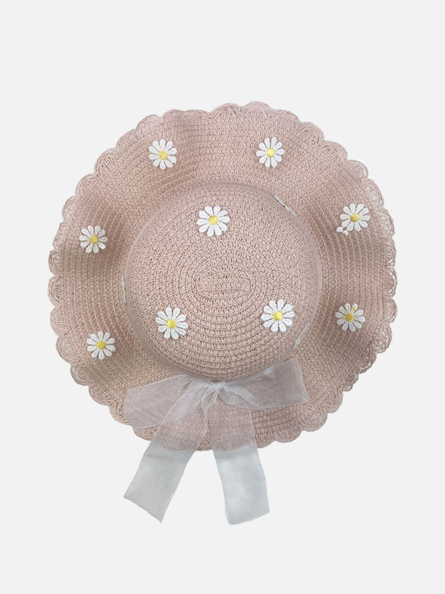 A charming beige straw purse and matching hat adorned with daisy patches and a sheer ribbon bow, perfect for spring outings.