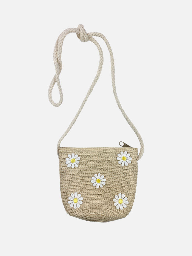 A charming beige straw purse and matching hat adorned with daisy patches and a sheer ribbon bow, perfect for spring outings.