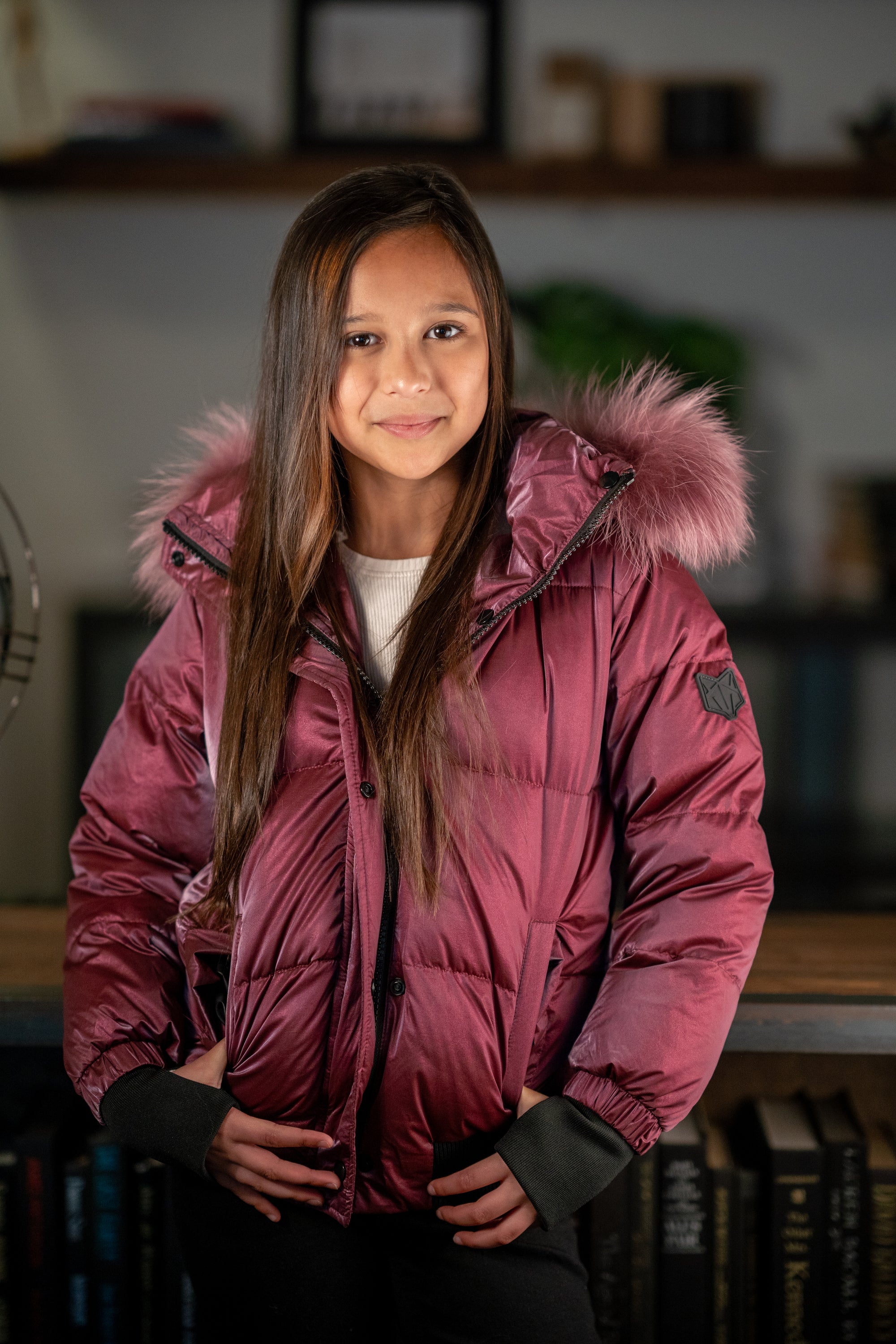 The Flamefruit coat featuring a luxurious racoon fur hood, sleek polyester exterior, and stylish design elements.