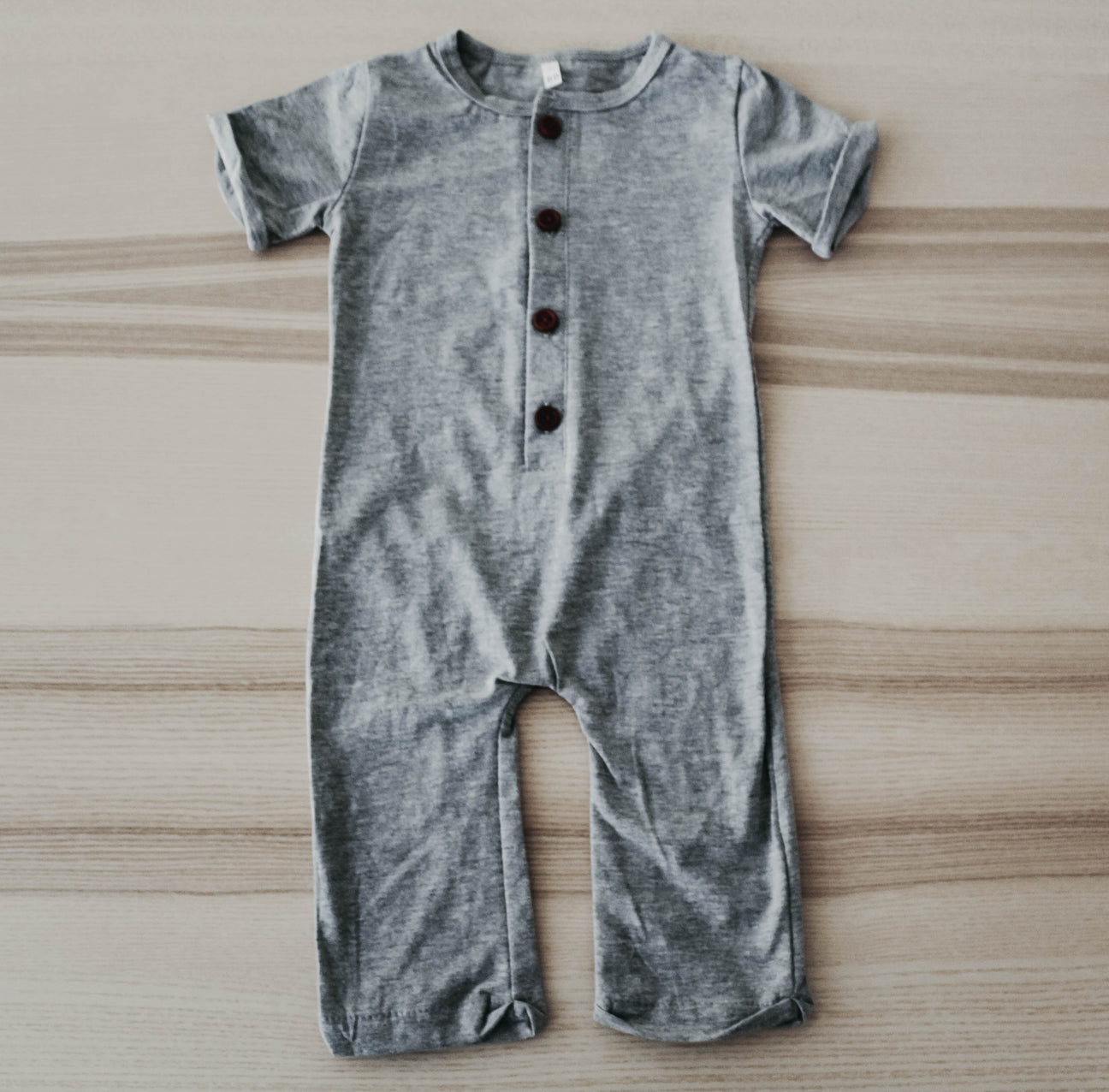 Stylish gray Liam romper made of soft cotton, featuring a comfortable fit and versatile design suitable for various occasions.