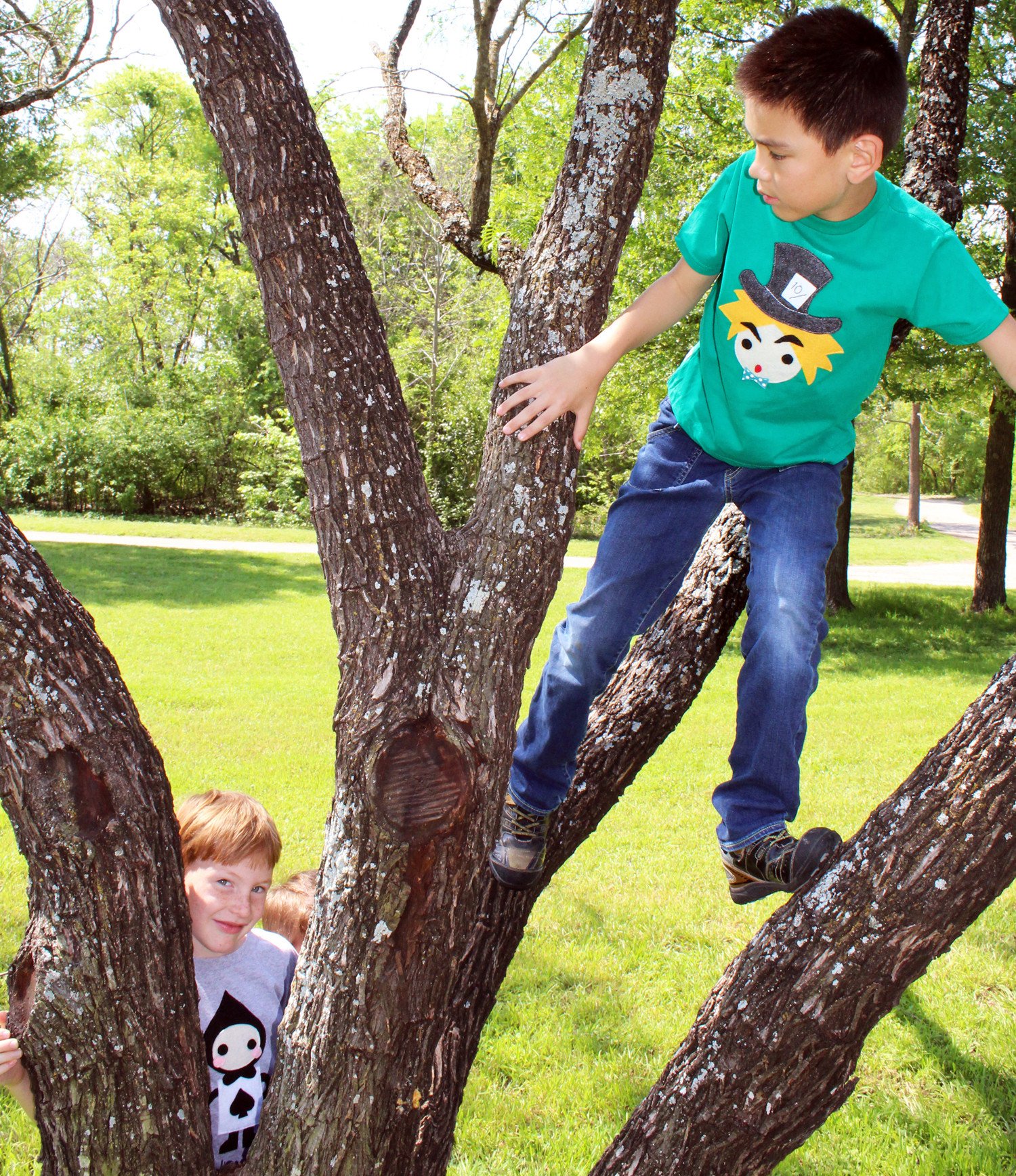 A colorful handmade kids t-shirt featuring The Hatter from Alice's Adventure in Wonderland, with eco felt appliqué design.