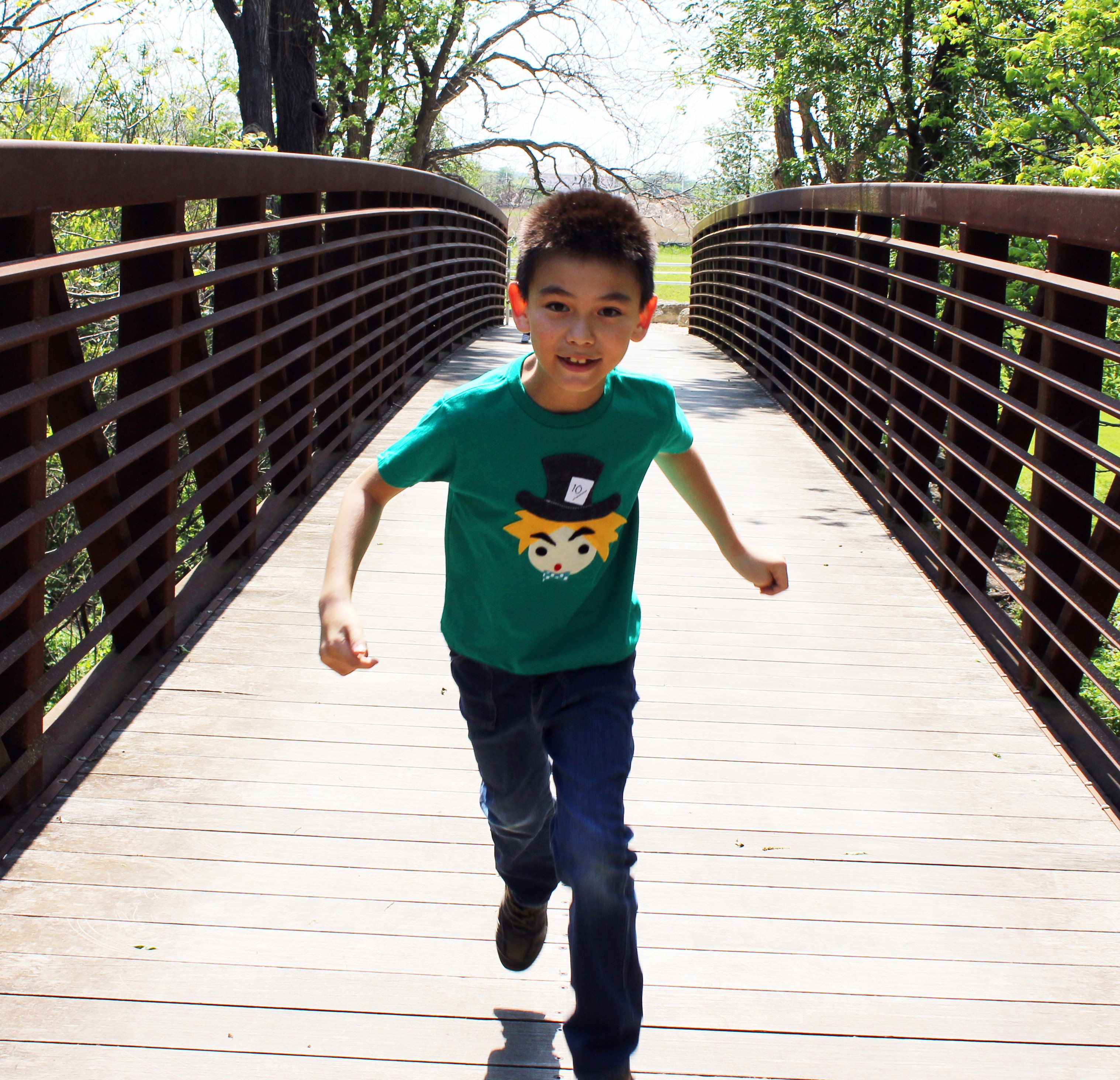 A colorful handmade kids t-shirt featuring The Hatter from Alice's Adventure in Wonderland, with eco felt appliqué design.