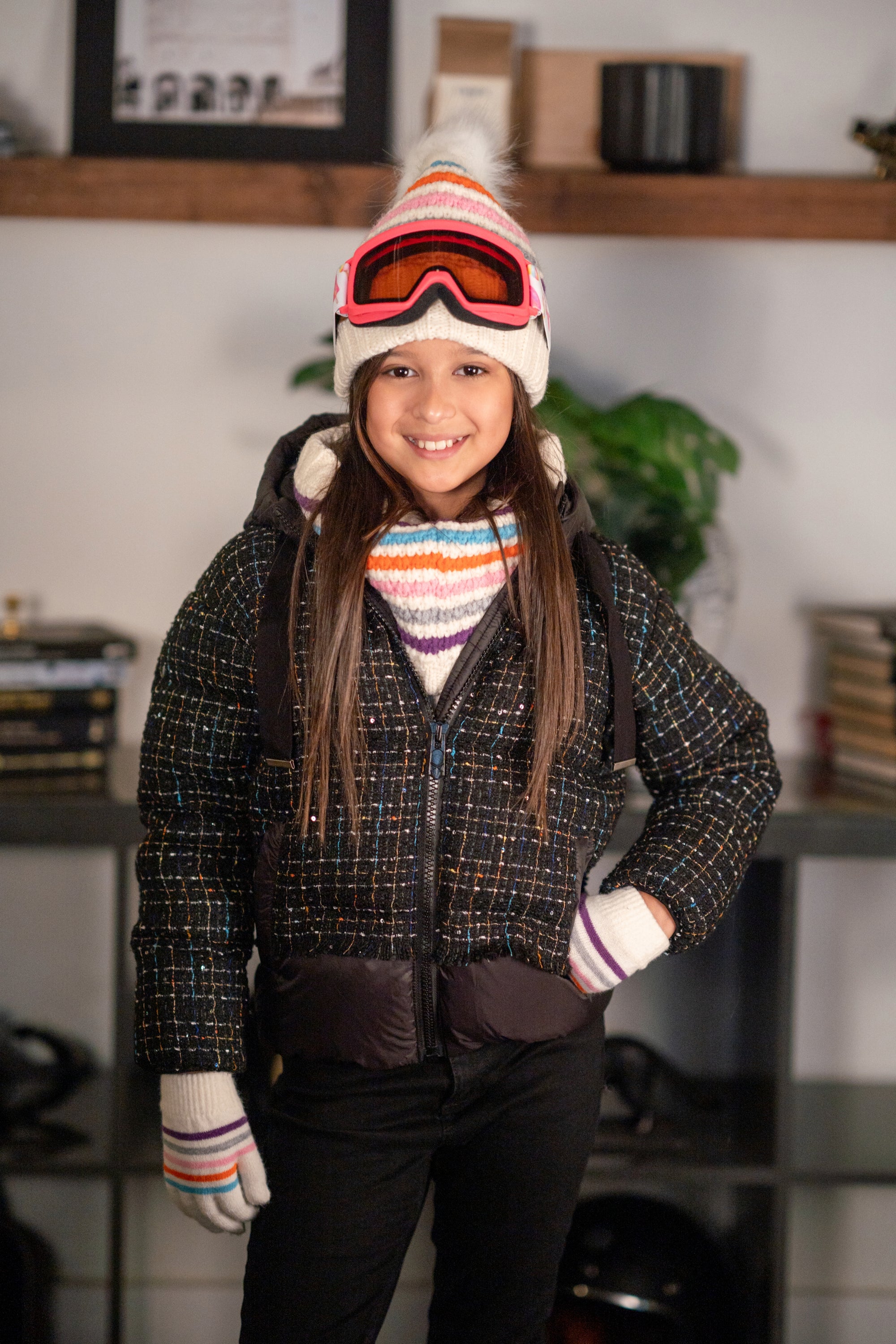 The Hushed Holly jacket featuring a vibrant speckled design, high collar, and adjustable hood with drawstrings.