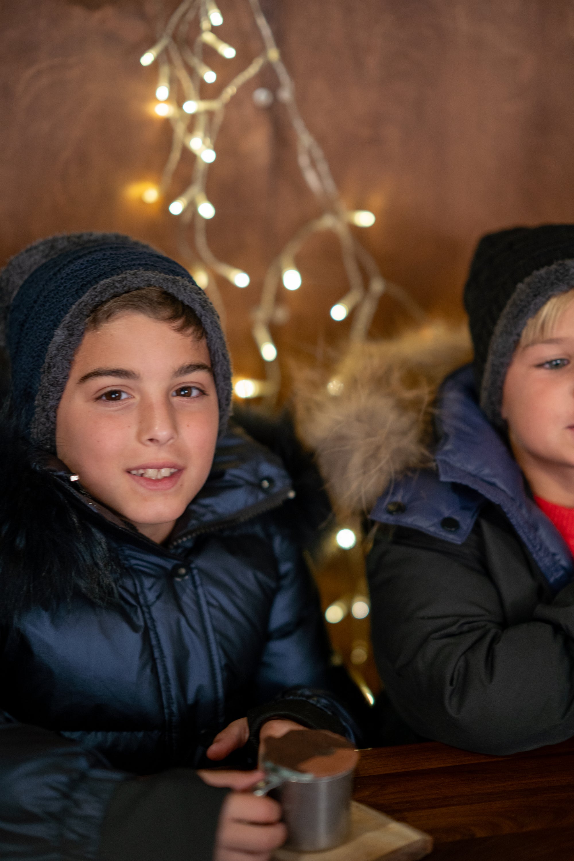The River Wye unisex coat in navy with fur trim, showcasing a stylish design with black speckles.