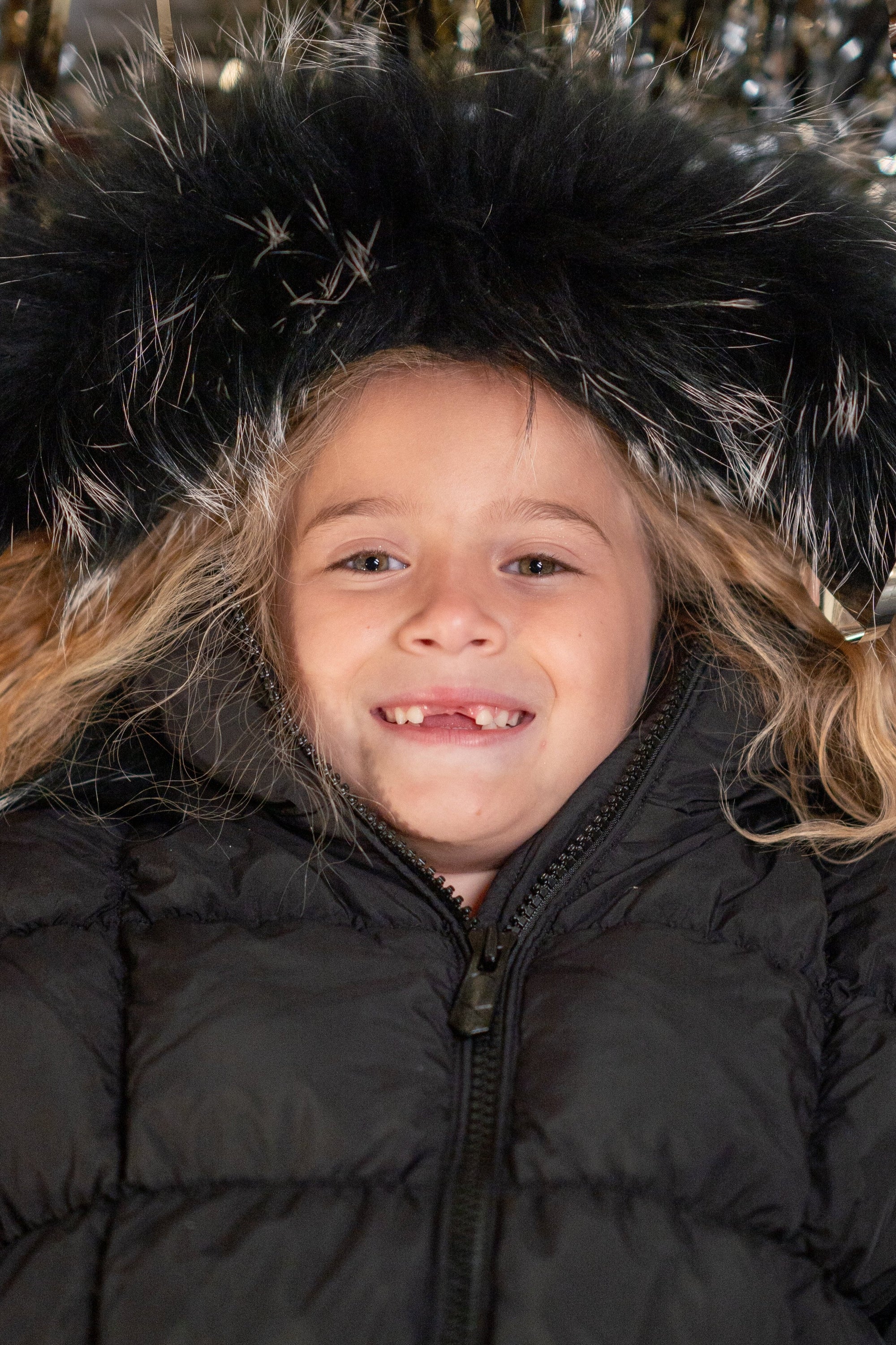 The Twizzle coat featuring a scrunched design with black and white tipped fur collar and hood, showcasing its luxurious and stylish appeal.