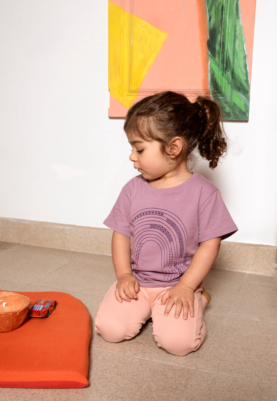 A vibrant purple T-shirt for babies and toddlers featuring a colorful rainbow print, perfect for casual wear.