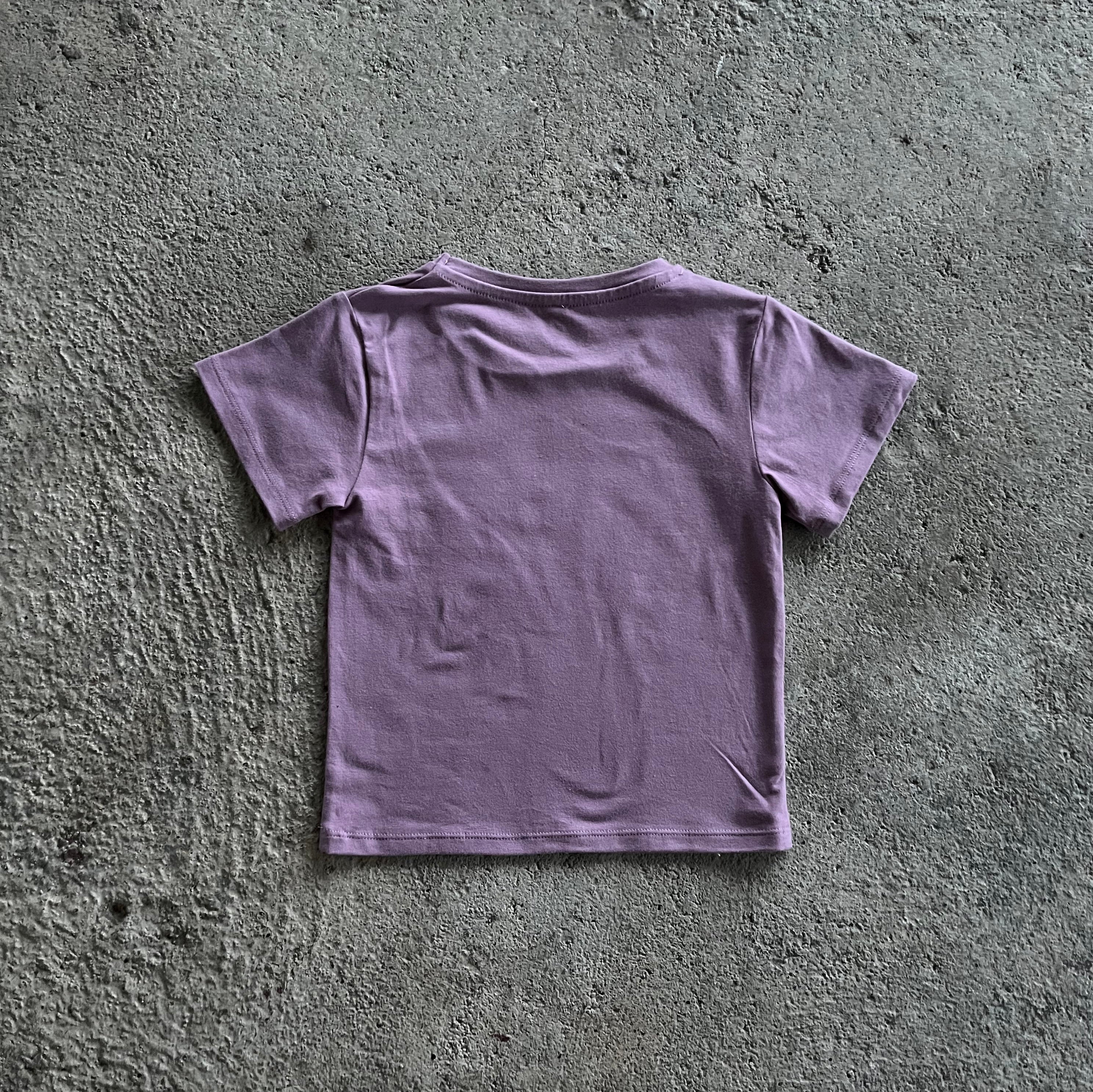 A vibrant purple T-shirt for babies and toddlers featuring a colorful rainbow print, perfect for casual wear.