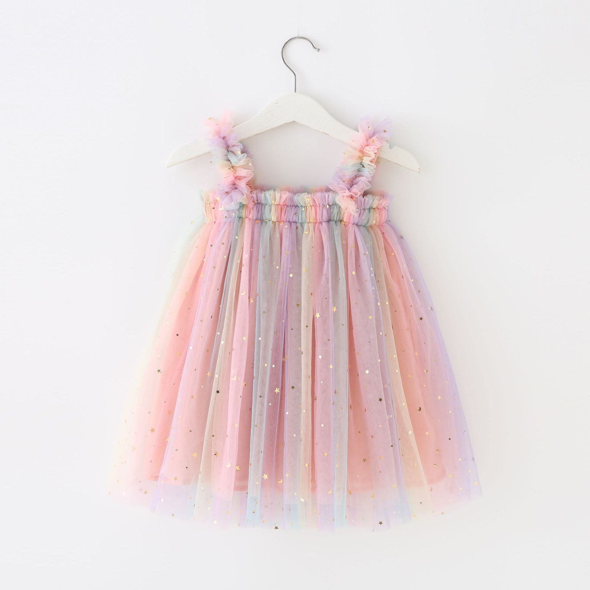 A beautiful tulle dress featuring a moon and stars print with a gradient of pastel colors including pink, purple, teal, and yellow.