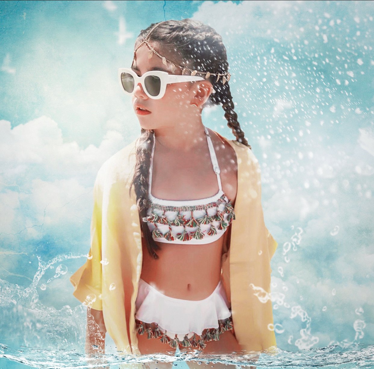 A stylish white bikini featuring vibrant multicolor tassels, perfect for summer beach outings.