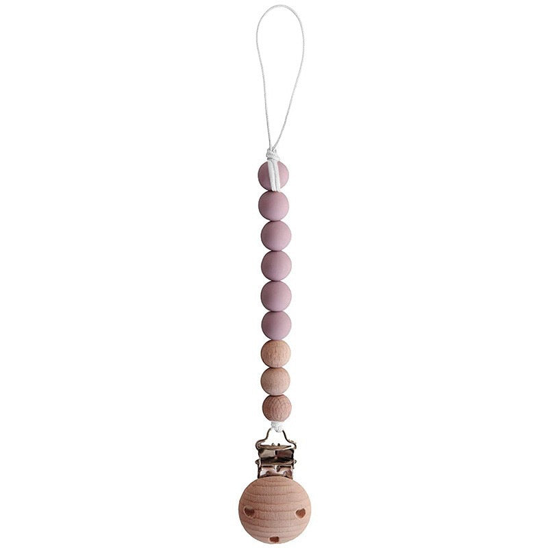 A set of colorful wooden pacifier clips, showcasing four different colors and a sturdy design for securing pacifiers.