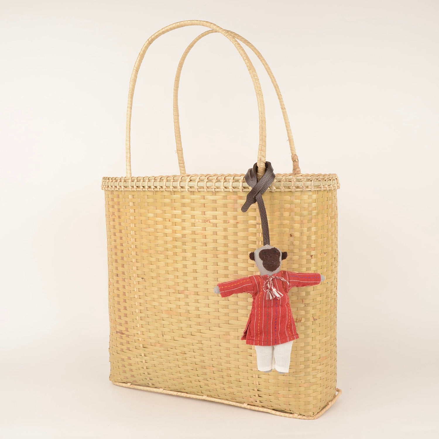 Handcrafted Bag Charm BC_NEELU_01 made from waste fabric with a stylish leather strap, showcasing unique artisan craftsmanship.