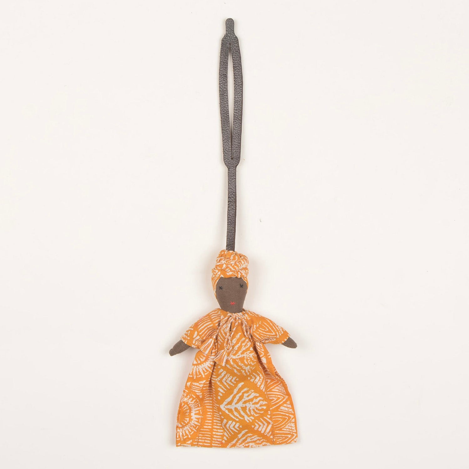Handcrafted Bag Charm BC_SOUMBA_01 made from waste fabric with a stylish leather strap, showcasing unique patterns and vibrant colors.