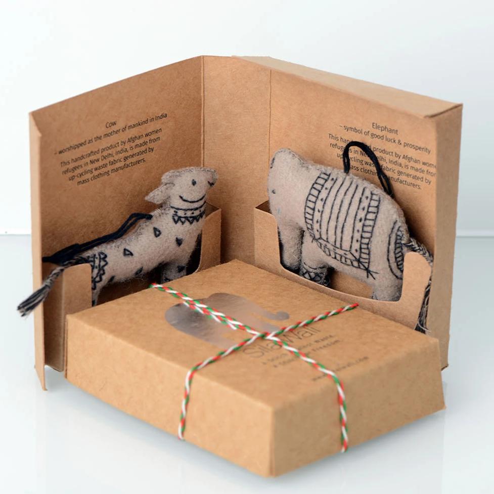 Handcrafted felt ornaments featuring a cow and elephant design, beautifully stitched and embroidered.