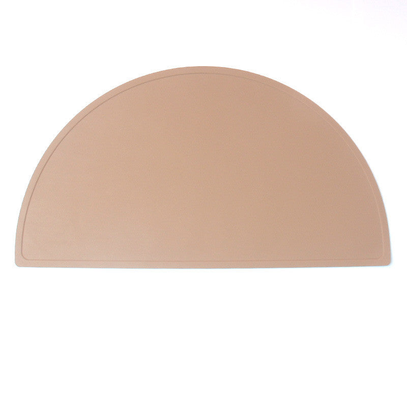 A round food grade silicone placemat in various colors, designed for children, showcasing its waterproof and stain-resistant features.