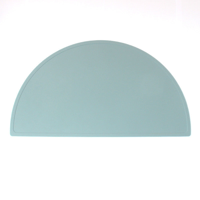 A round food grade silicone placemat in various colors, designed for children, showcasing its waterproof and stain-resistant features.