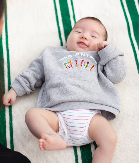 Limited Edition Mon Coeur Fait Boum Mini sweatshirt in heather grey with vibrant African Wax Fabric letters.