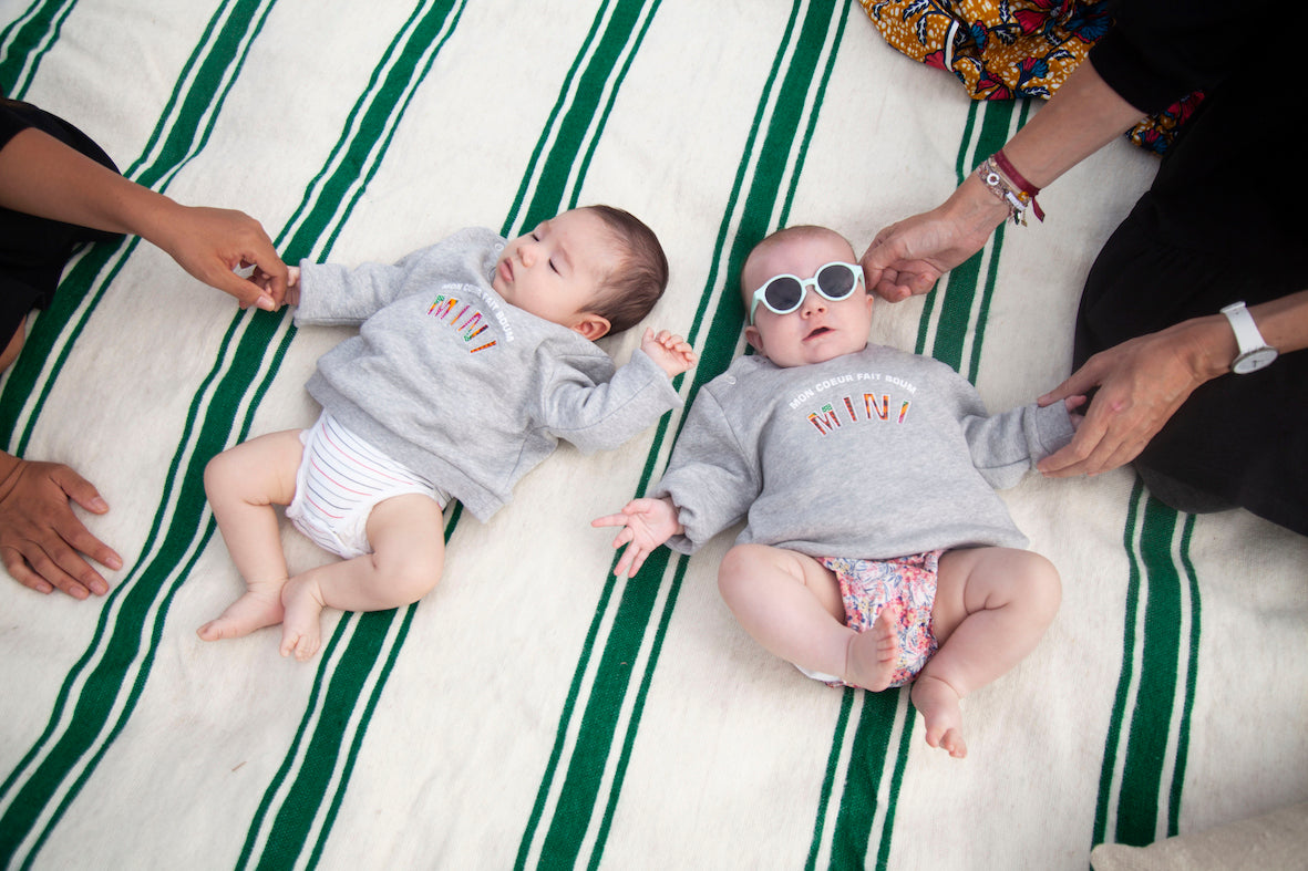 Limited Edition Mon Coeur Fait Boum Mini sweatshirt in heather grey with vibrant African Wax Fabric letters.