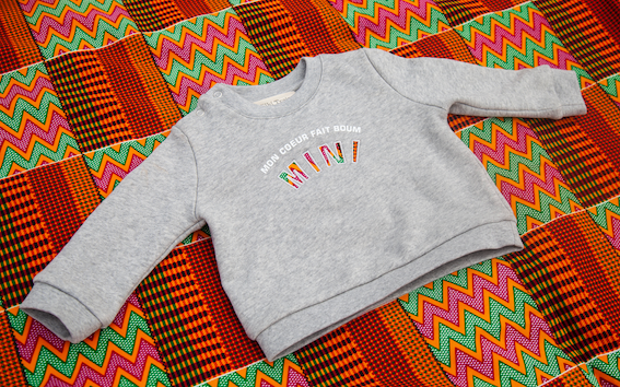 Limited Edition Mon Coeur Fait Boum Mini sweatshirt in heather grey with vibrant African Wax Fabric letters.