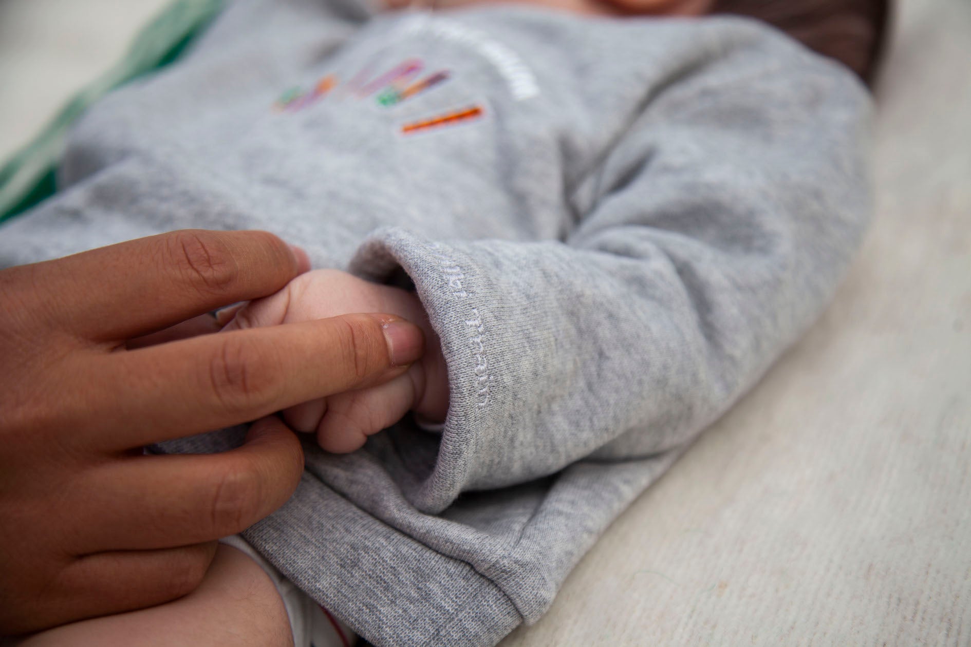 Limited Edition Mon Coeur Fait Boum Mini sweatshirt in heather grey with vibrant African Wax Fabric letters.