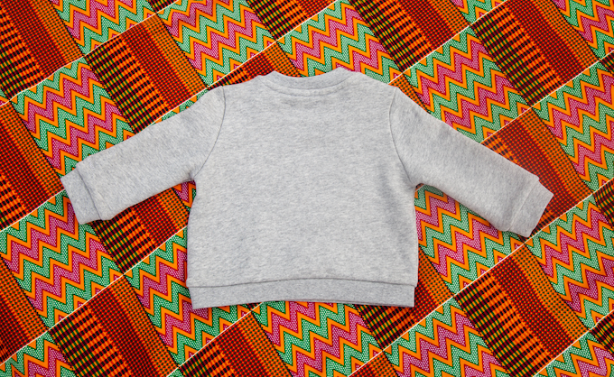 Limited Edition Mon Coeur Fait Boum Mini sweatshirt in heather grey with vibrant African Wax Fabric letters.