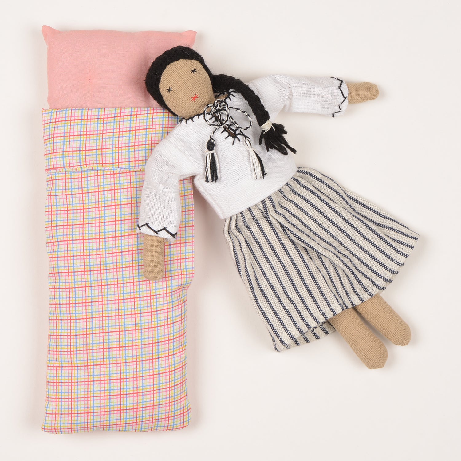 Mini Maya doll handcrafted by Afghan artisans, featuring a long skirt, long-sleeved blouse, and braided hair, packaged in a foldable box.