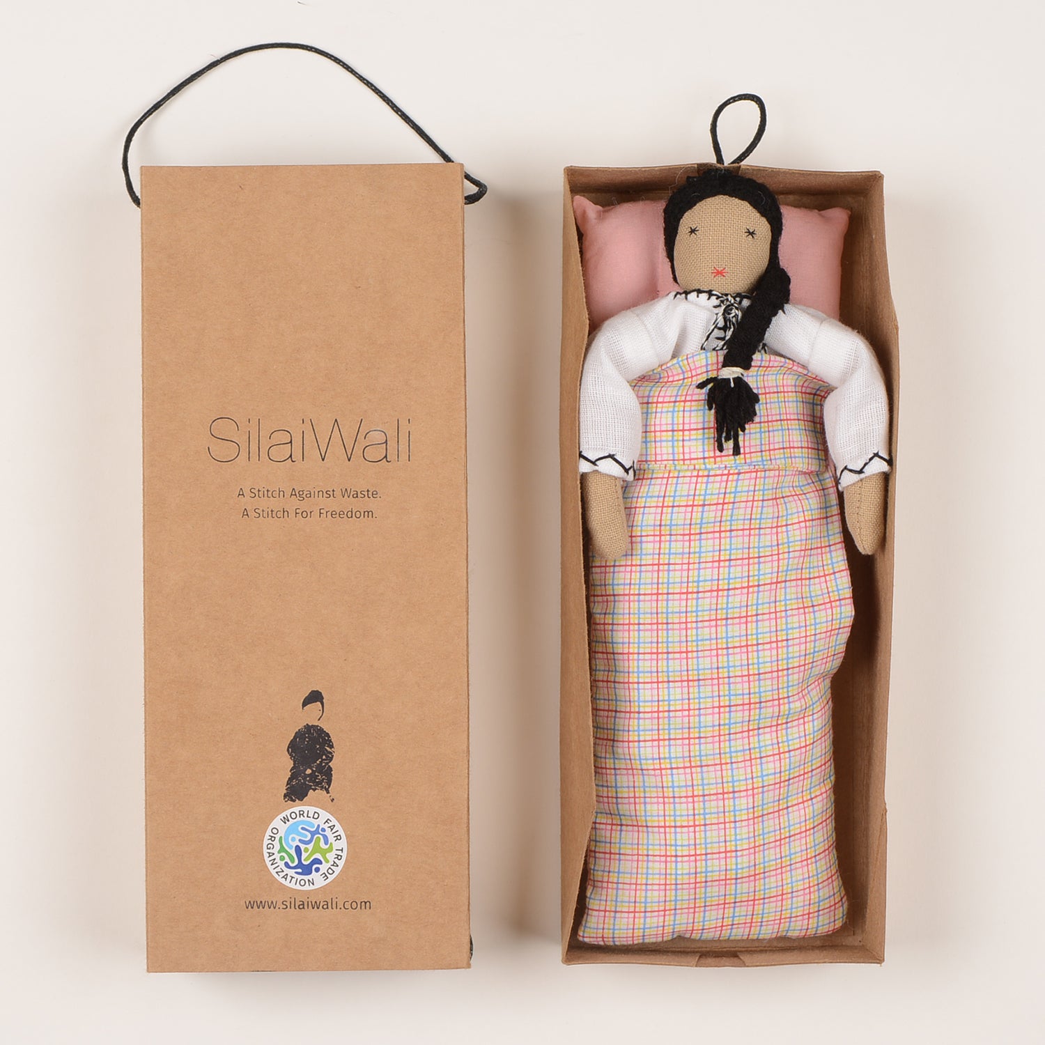 Mini Maya doll handcrafted by Afghan artisans, featuring a long skirt, long-sleeved blouse, and braided hair, packaged in a foldable box.