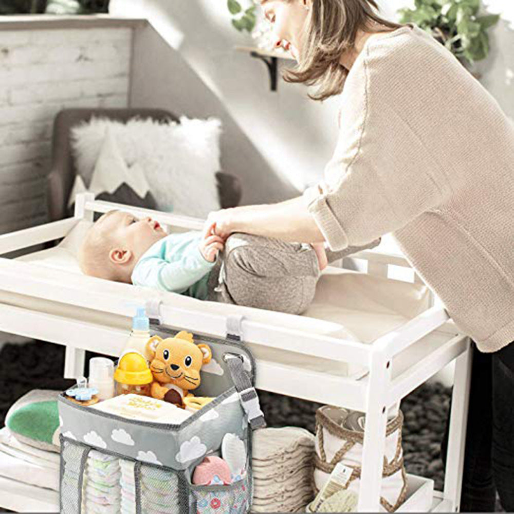 Portable Baby Crib Organizer Bed Hanging Bag in a nursery setting, showcasing its compartments for baby items.