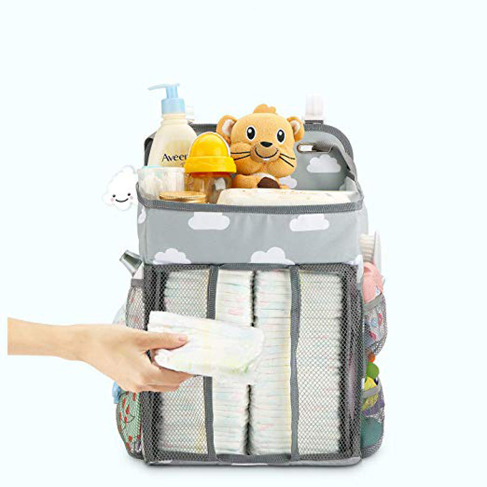 Portable Baby Crib Organizer Bed Hanging Bag in a nursery setting, showcasing its compartments for baby items.
