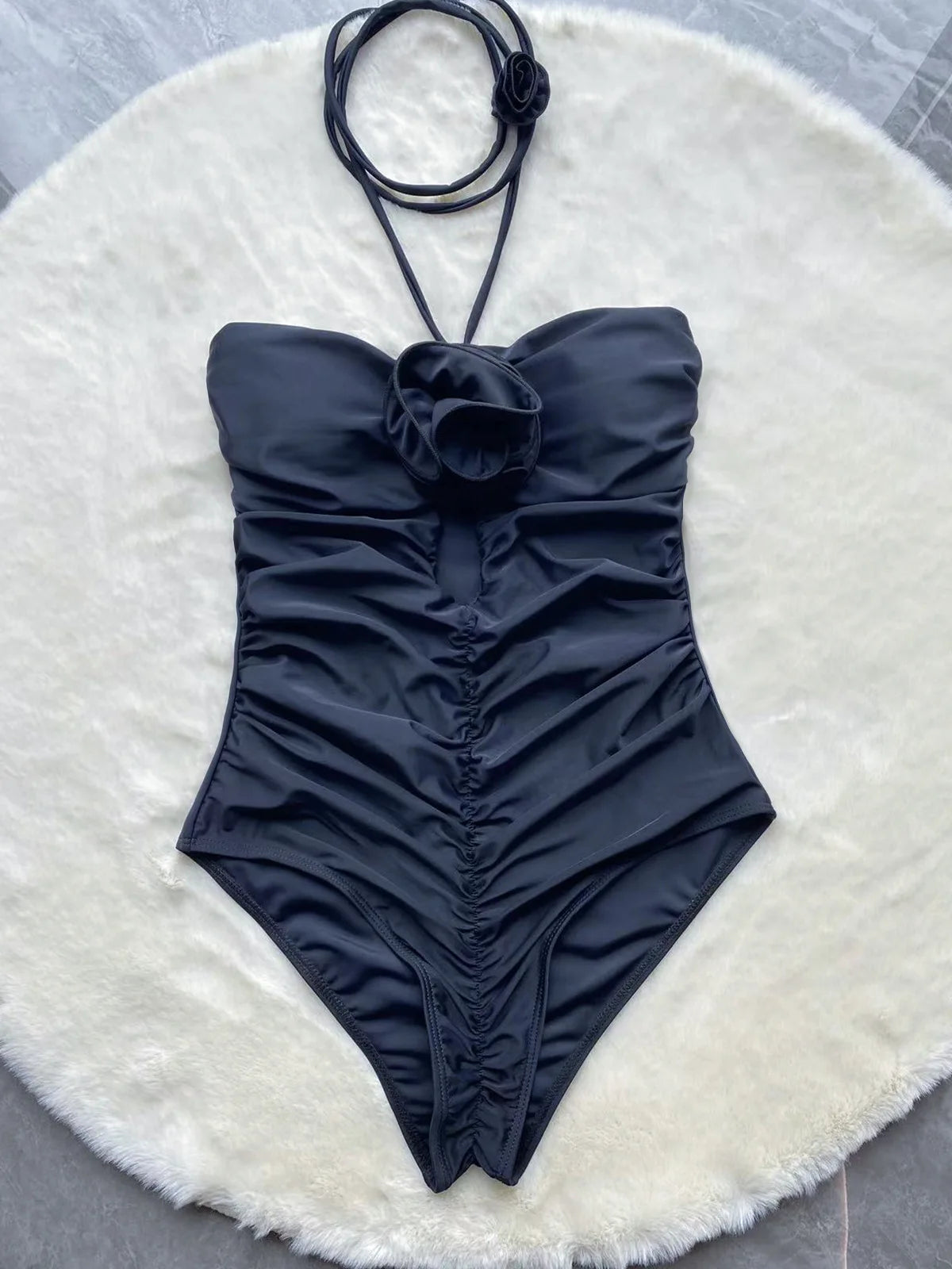 Black rose one piece swimsuit showcasing elegant design and flattering fit for women.