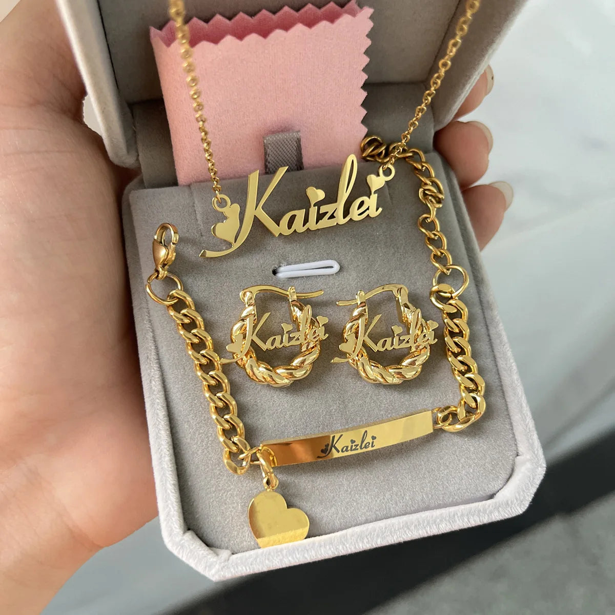 Cute mini personalized jewelry set featuring a heart design, made of stainless steel, includes necklace, earrings, and bracelet in gold, silver, and rose gold.