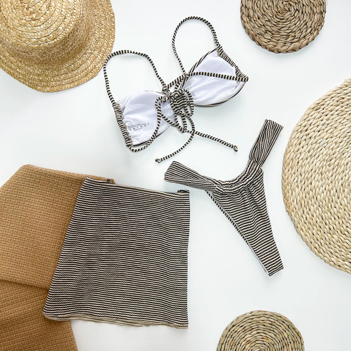 Melia three piece vacation swimsuit with cover up featuring high waist design and striped pattern in brown color.