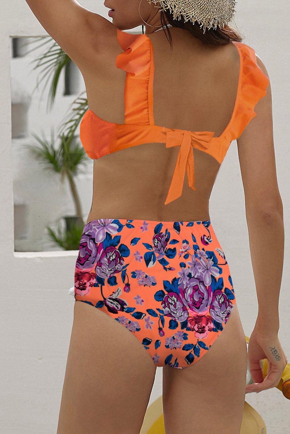 Orange ruffle bikini top with printed high waist panty, showcasing stylish design and vibrant color, perfect for summer beachwear.