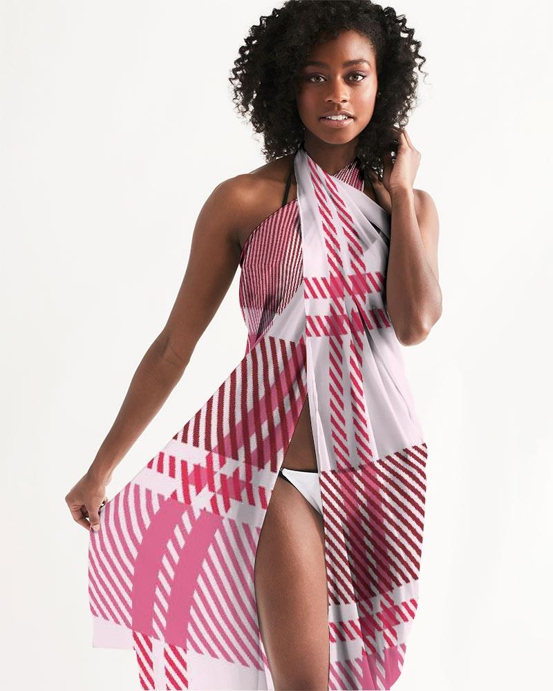 A stylish sheer plaid pink swimsuit cover up draped elegantly, showcasing its lightweight fabric and self-tie closure.