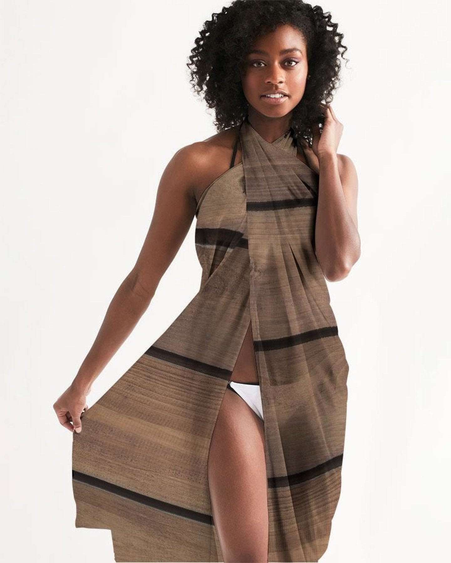 A lightweight sheer sarong swimsuit cover-up wrap in brown wood color, elegantly draped and showcasing its flowy fabric and self-tie closure.
