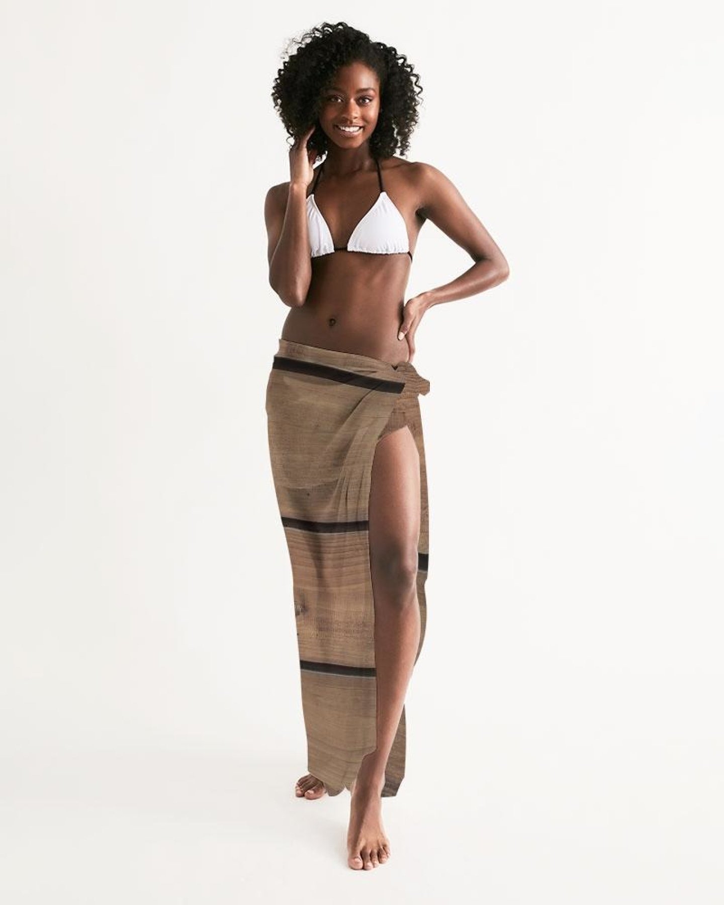 A lightweight sheer sarong swimsuit cover-up wrap in brown wood color, elegantly draped and showcasing its flowy fabric and self-tie closure.