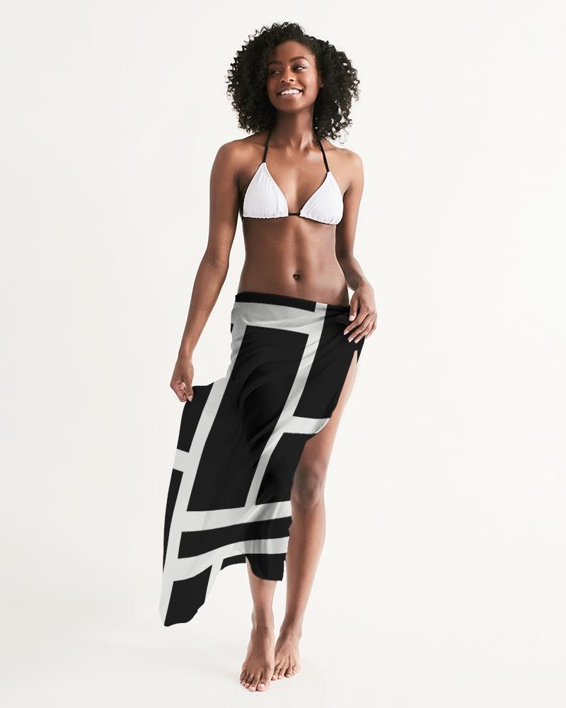 A stylish sheer sarong swimsuit cover-up featuring a geometric black and white design, perfect for beach or poolside wear.