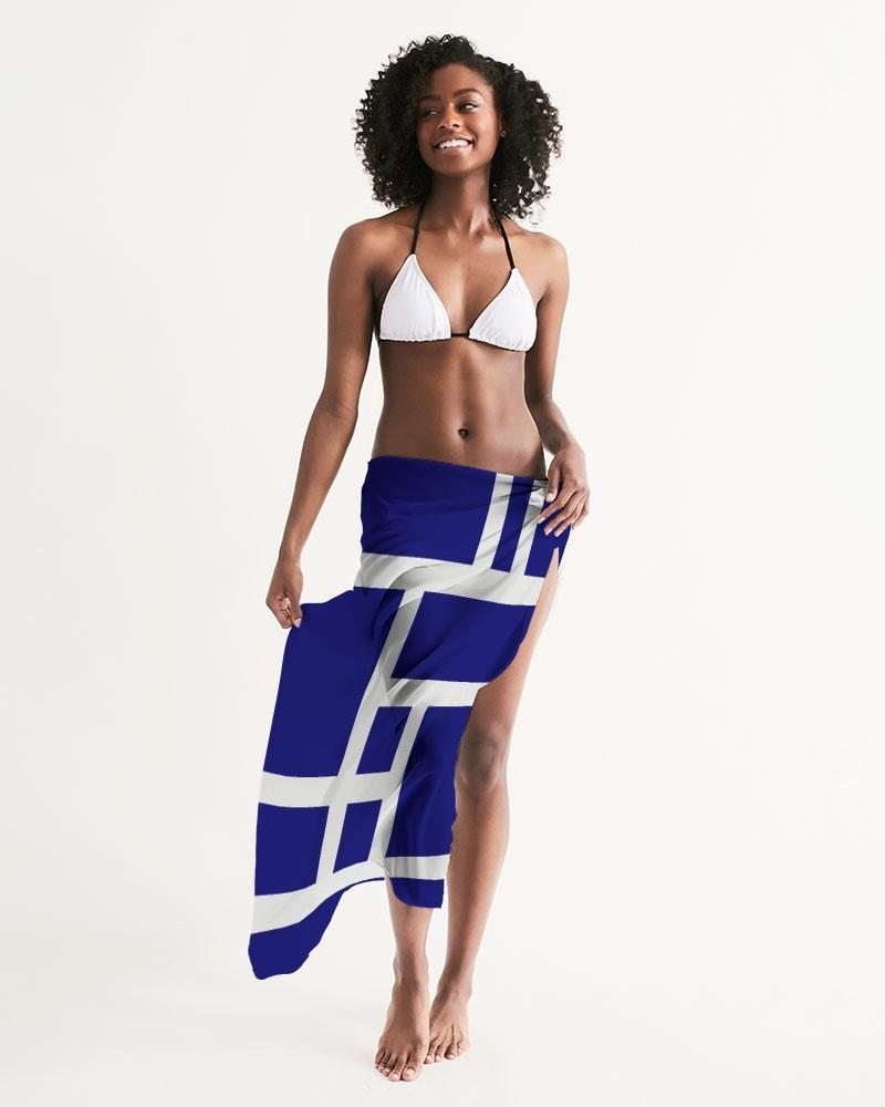 A sheer sarong swimsuit cover up wrap featuring a geometric dark blue and white design, elegantly draped on a model.