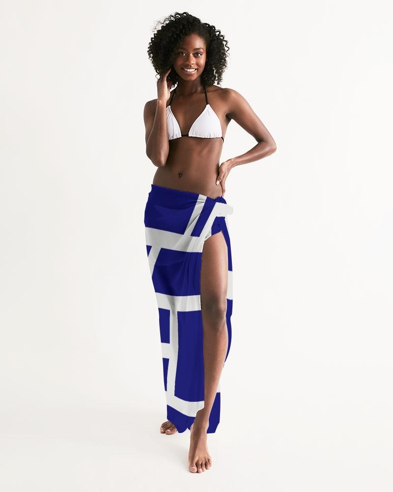 A sheer sarong swimsuit cover up wrap featuring a geometric dark blue and white design, elegantly draped on a model.