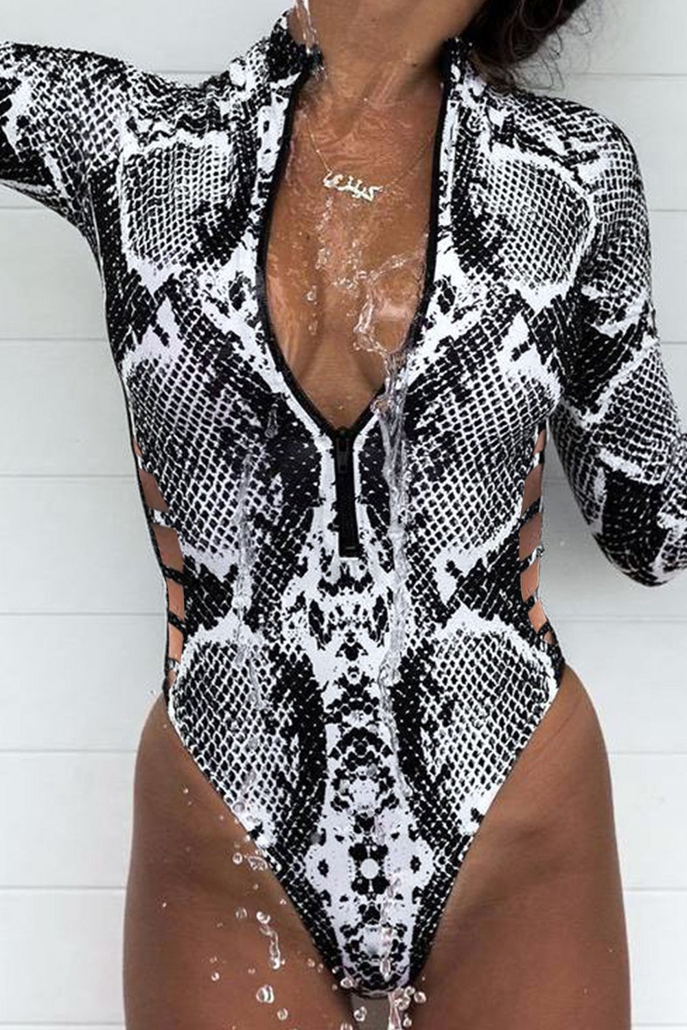 A stylish Sleeve Rash Guard Swimsuit featuring wild patterns, adjustable zipper neckline, and hollowed waist design for a flattering fit.