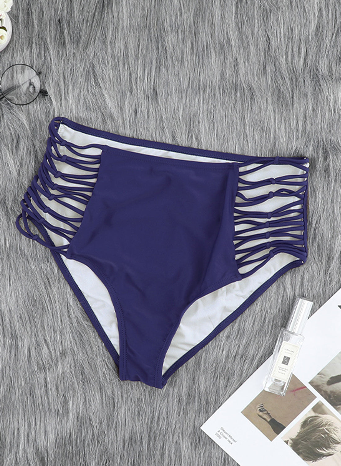 Women's blue swim bottoms featuring hollow-out sides and high waist design, perfect for summer beachwear.