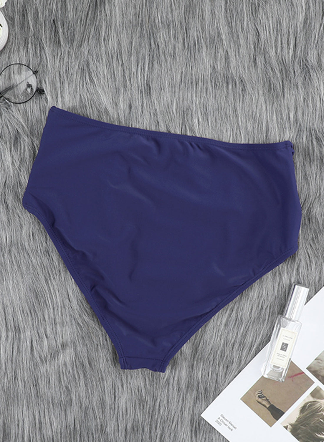 Women's blue swim bottoms featuring hollow-out sides and high waist design, perfect for summer beachwear.