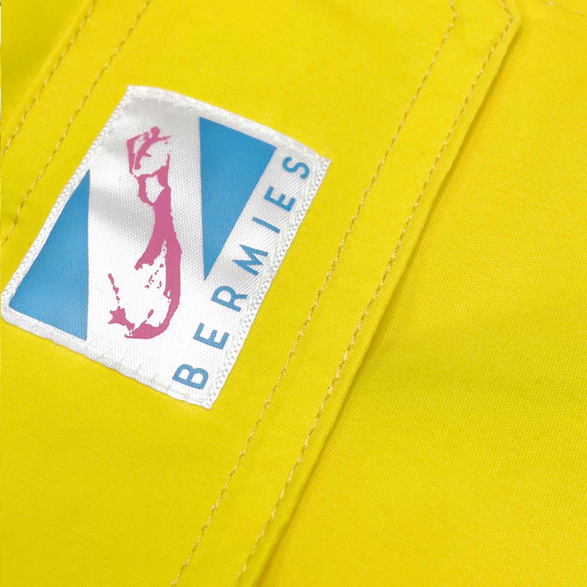 Color-changing swim trunks transitioning from yellow to orange in water, showcasing eco-friendly fabric and stylish design.