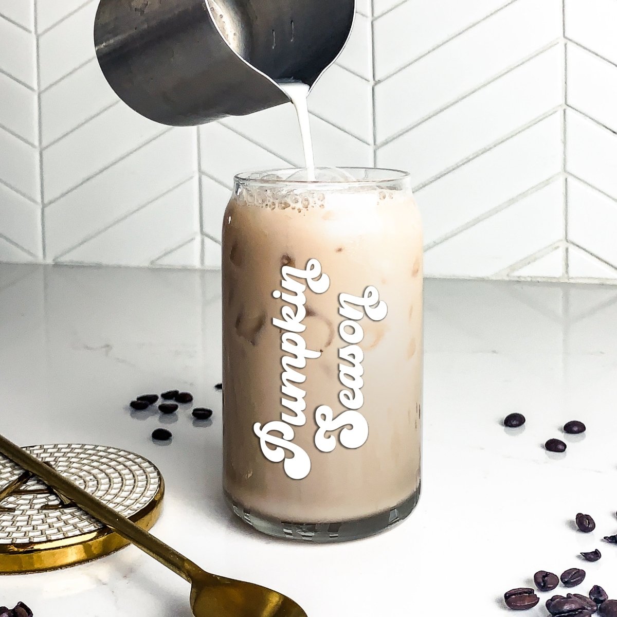 A stylish 16 oz Beer Can Glass with a unique design, perfect for serving cold drinks during pumpkin season.