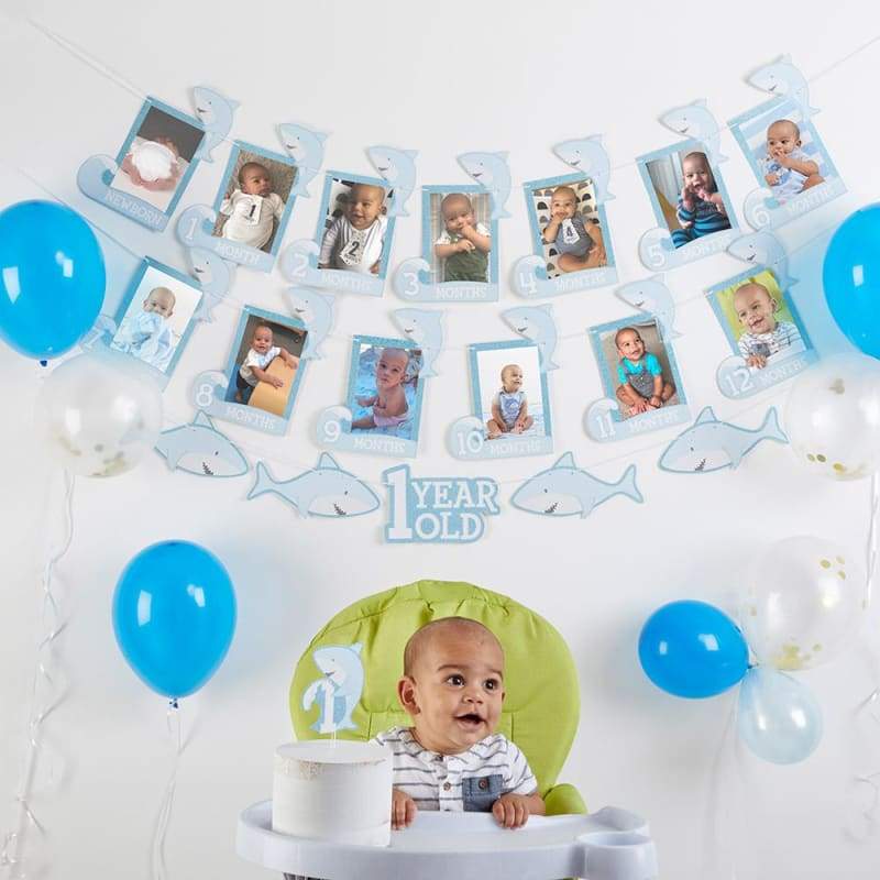 1st Birthday Milestone Photo Banner and Cake Topper featuring shark theme with blue and gold accents, perfect for celebrating a child's first birthday.