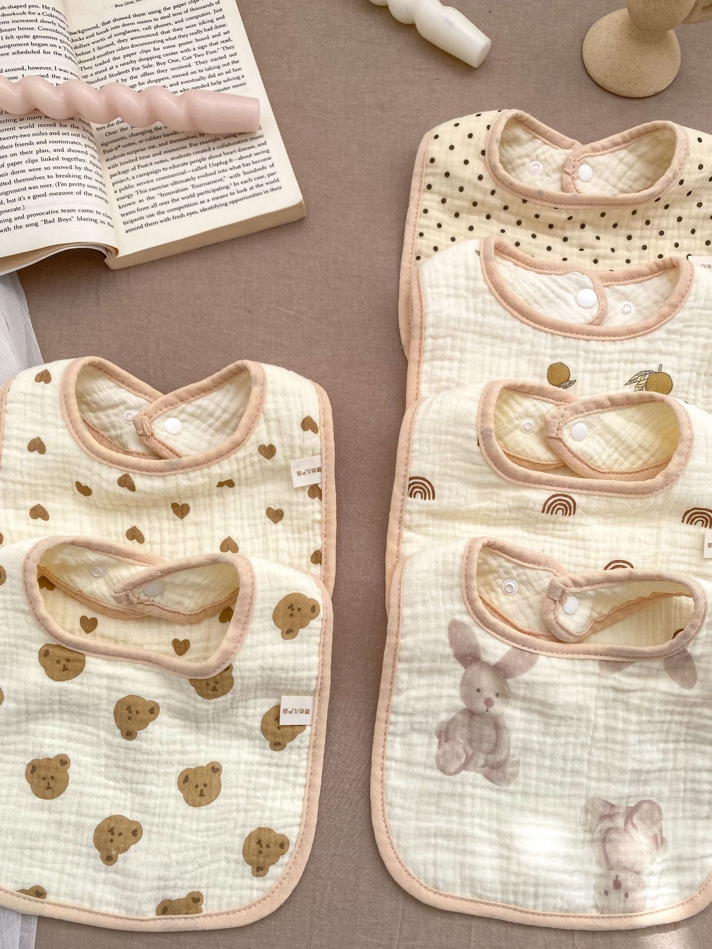 Adorable U-shaped cotton muslin bib featuring cute cartoon designs, perfect for babies.