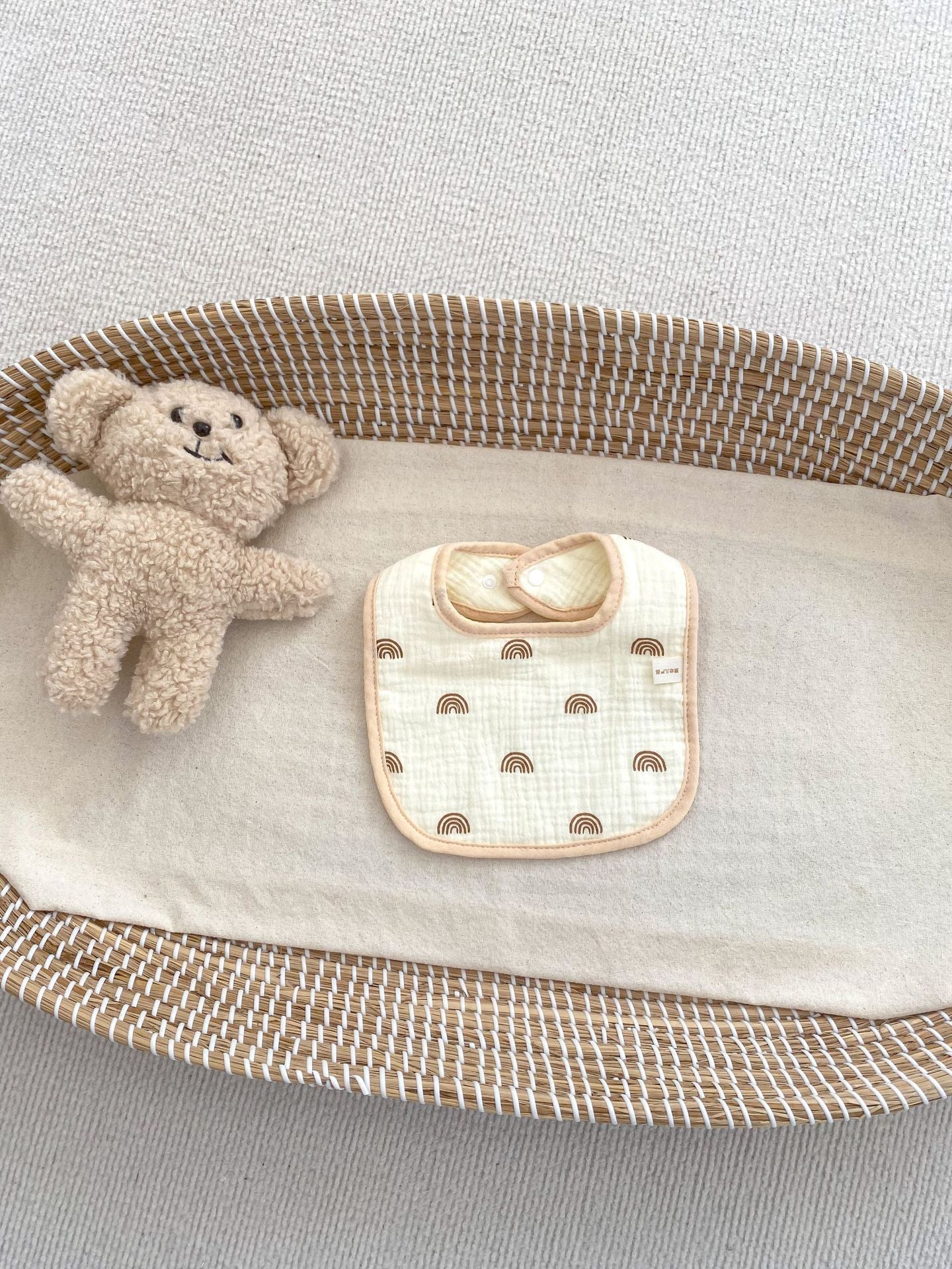 Adorable U-shaped cotton muslin bib featuring cute cartoon designs, perfect for babies.