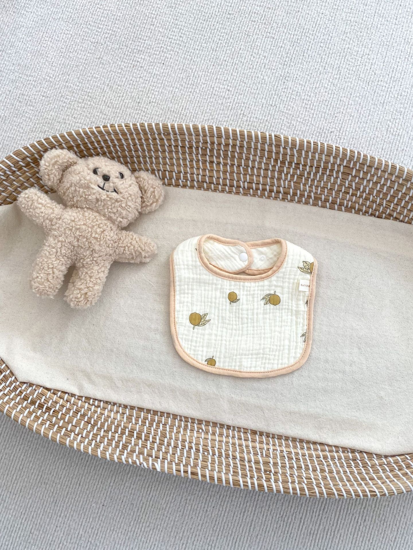 Adorable U-shaped cotton muslin bib featuring cute cartoon designs, perfect for babies.