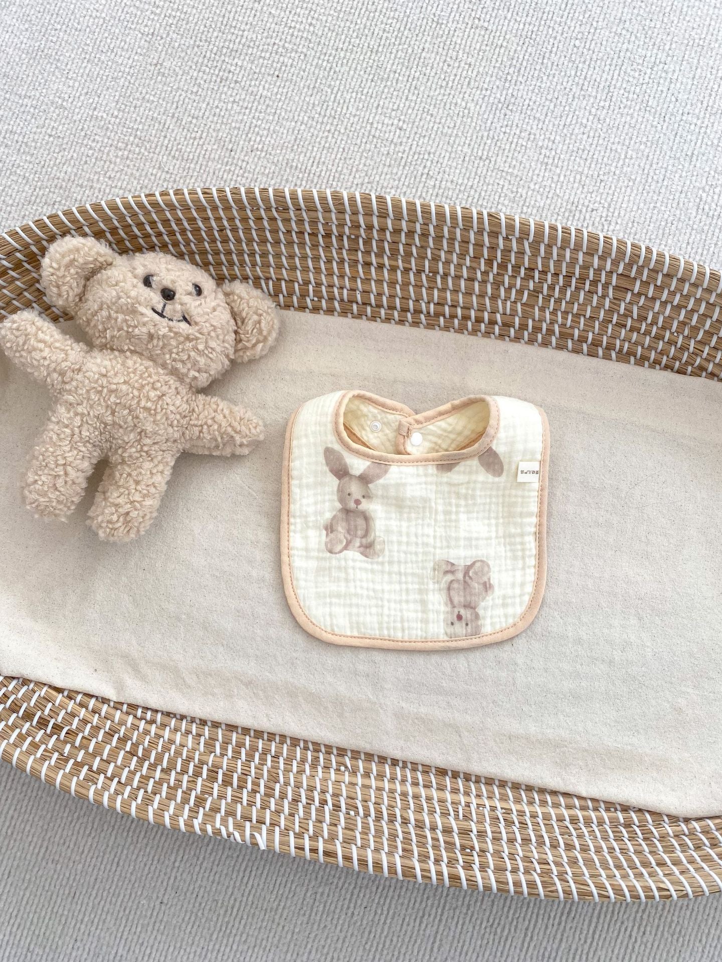 Adorable U-shaped cotton muslin bib featuring cute cartoon designs, perfect for babies.