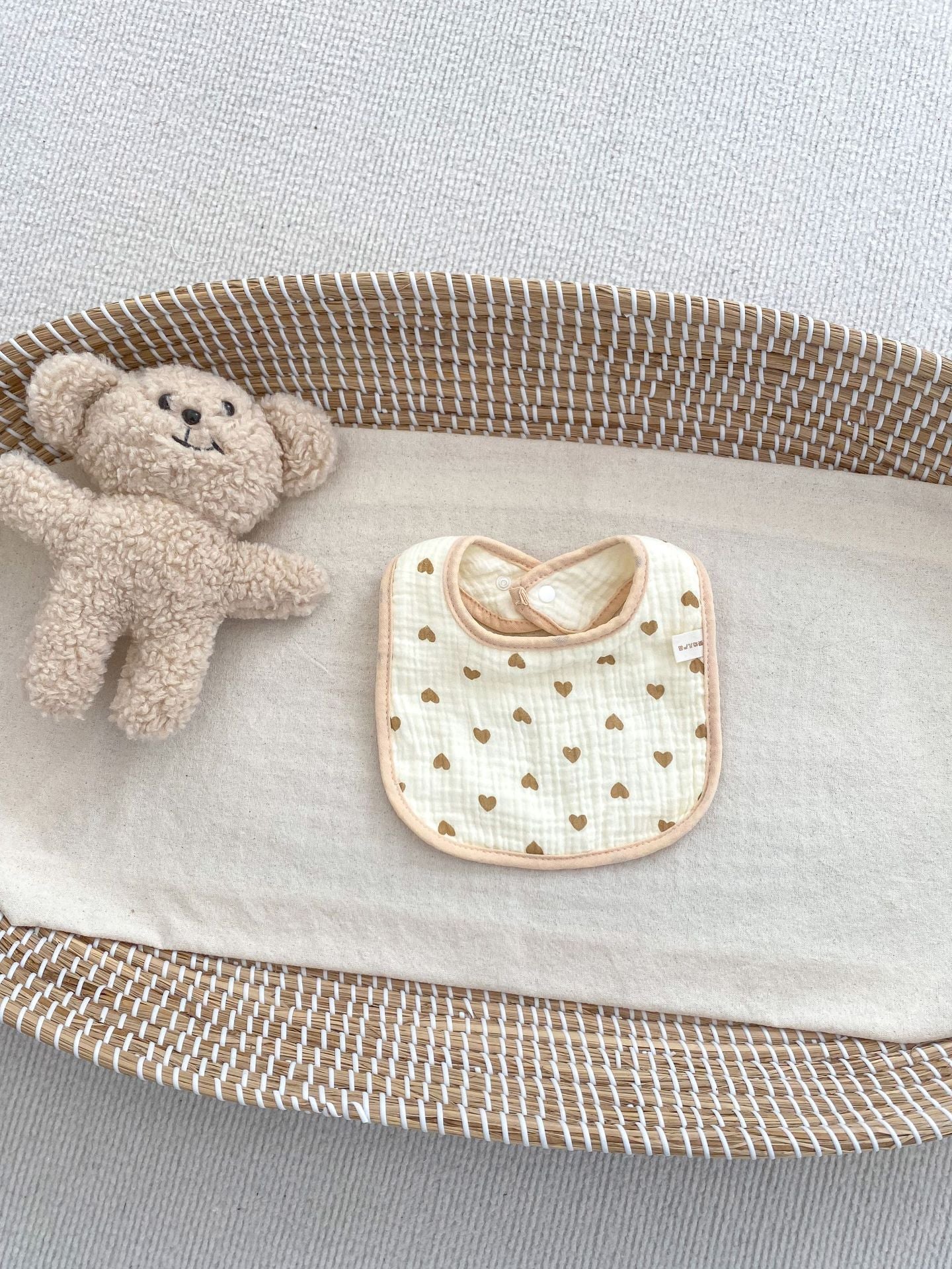 Adorable U-shaped cotton muslin bib featuring cute cartoon designs, perfect for babies.